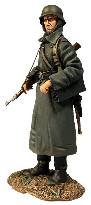 WW2: German Volksgrenadier Standing with Ammo Can in Greatcoat